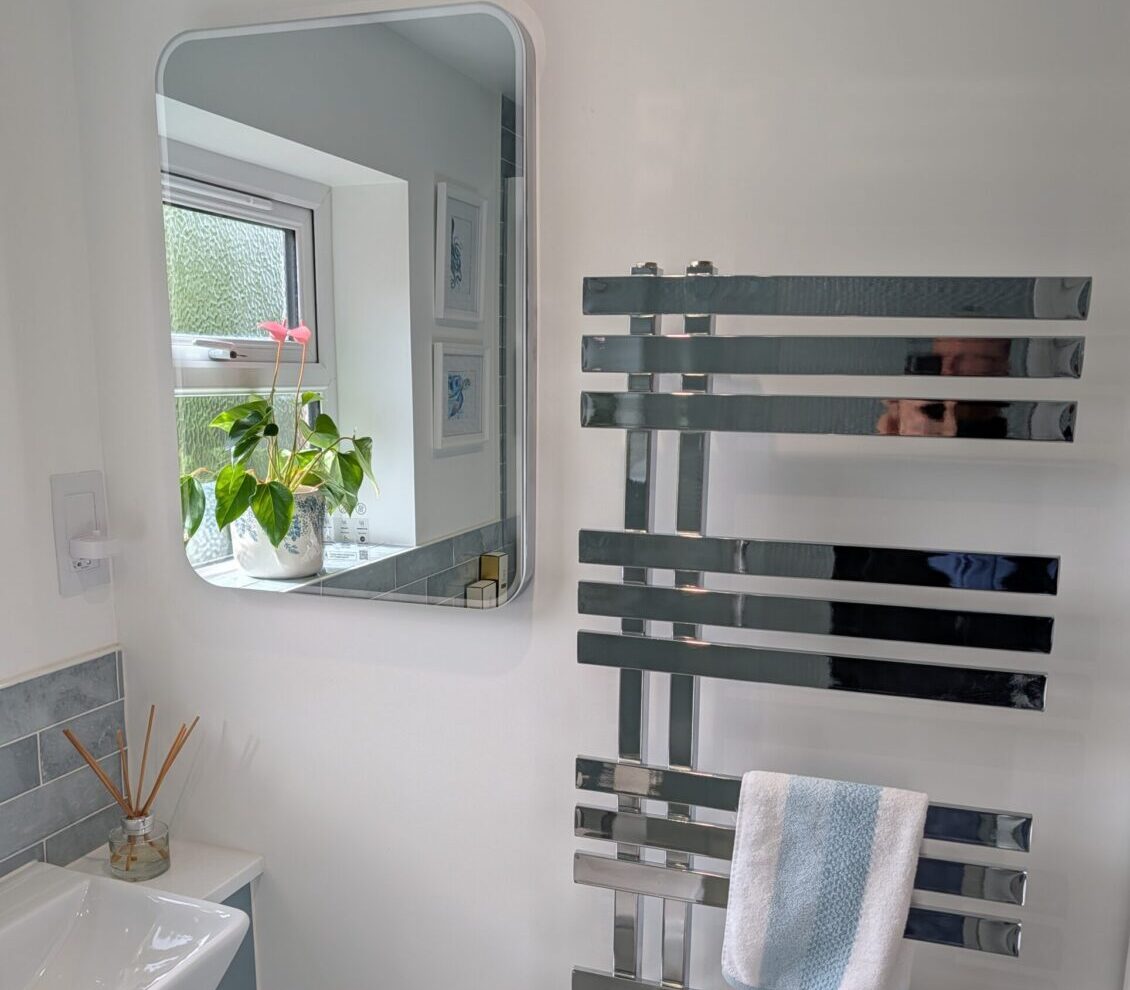 mirror and towel rack in the new luxury bathroom installation
